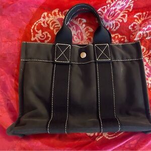 Classic Hermès black canvas tote. In good used condition. Has certificate.